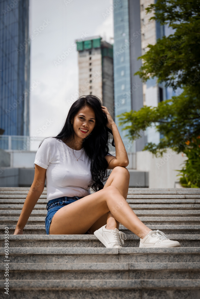 Fototapeta premium girl sitting on the stairs in the city