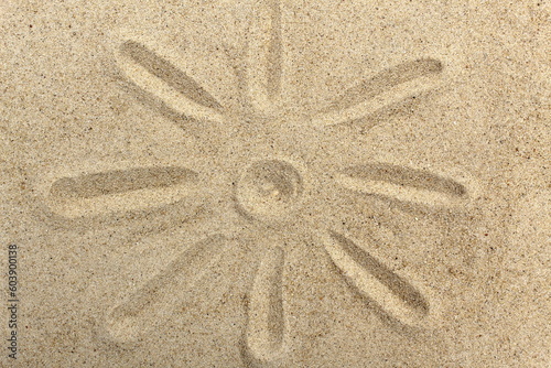 The sun is painted on the sand.