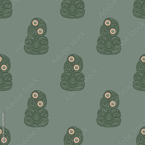 Seamless ethnic pattern with Hei-tiki pendant of the Māori of New Zealand. Green stone carvings with inlaid eyes. Totem figurines. On green background. photo