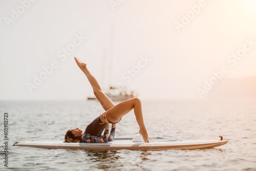 Woman sup yoga. Middle age sporty woman practising yoga pilates