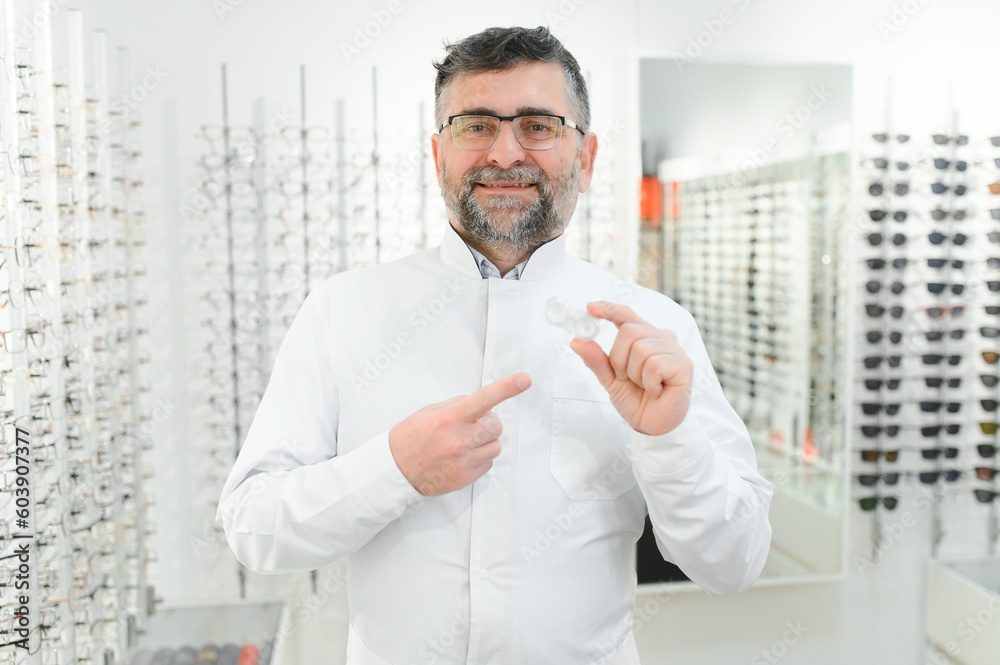 Doctor holds in his hand container with soft contact lenses for single use. Ophthalmologist prescribes use of one-day contact lenses for vision correction. Myopia and eyesight problem concept.