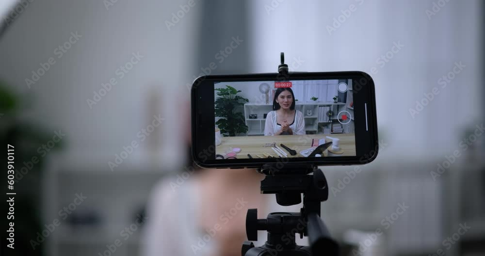 Handheld shot, Close-up phone view, Beautiful asian woman blogger is showing how to make up and use cosmetics. In front of the smartphone to record vlog video. Influencer and cosmetics concepts. Handheld shot, Close-up phone view, Beautiful asian woman blogger is showing how to make up and use cosmetics. In front of the smartphone to record vlog video. Influencer and cosmetics concepts.