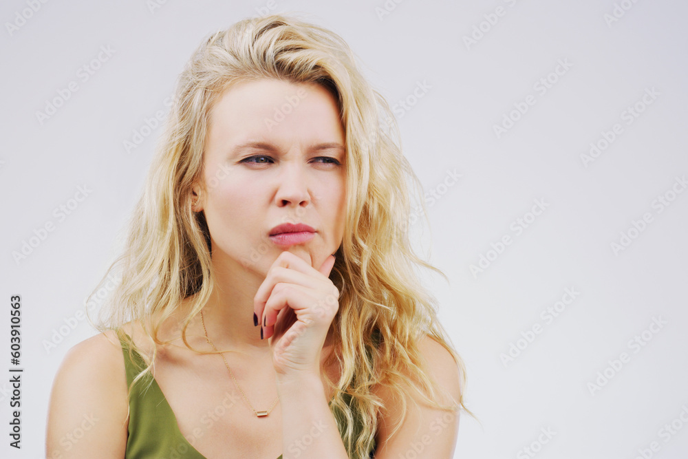 Young woman, thinking and confused in studio with ideas, memory and focus by gray background. Girl, model and think with concentration, remember and decision for choice, planning or question on mind Young woman, thinking and confused in studio with ideas, memory and focus by gray background. Girl, model and think with concentration, remember and decision for choice, planning or question on mind