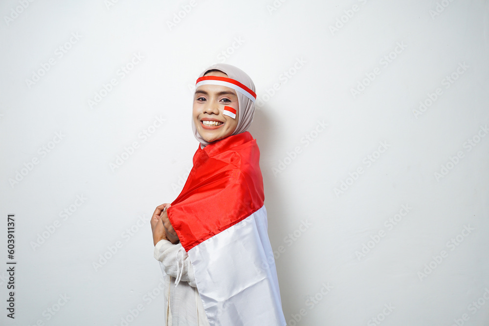 Portrait of Young Asian Muslim Women celebrate Indonesian independence day holding red and white flag Portrait of Young Asian Muslim Women celebrate Indonesian independence day holding red and white flag