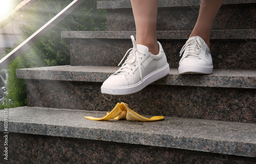 Foot stepping on a banana peel on steps photo