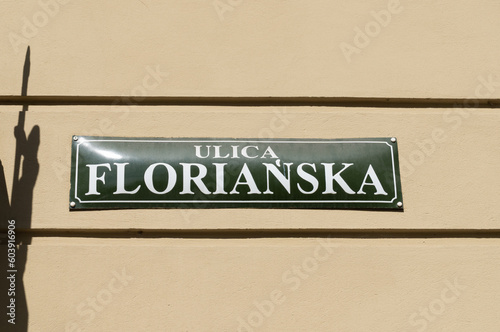 Floriańska street name sign in the Old Town district of Krakow, Poland. Information plate on a building wall in Kraków. St. Florian's Florianska, famous promenade, one of the main streets of Cracow.
