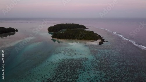 Aerial video of islands off the coast of Mo'orea in French Polynesia at sunrise