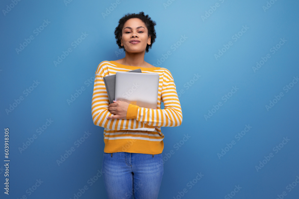 pretty afro brunette latin young office woman holding laptop
