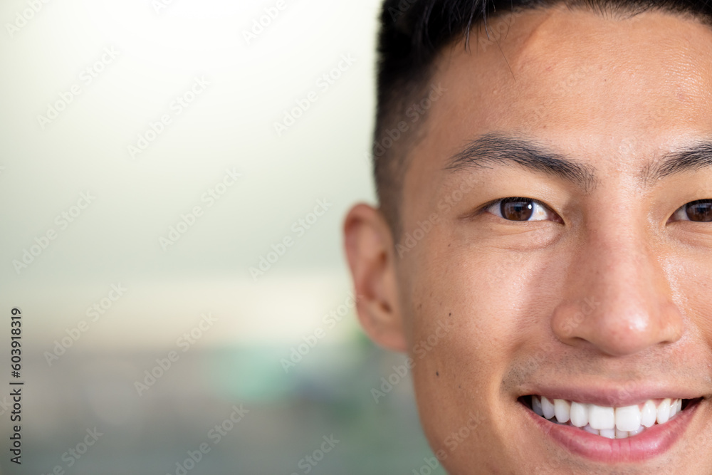 Half portrait of unaltered happy asian male doctor smiling to camera at hospital, copy space Half portrait of unaltered happy asian male doctor smiling to camera at hospital, copy space