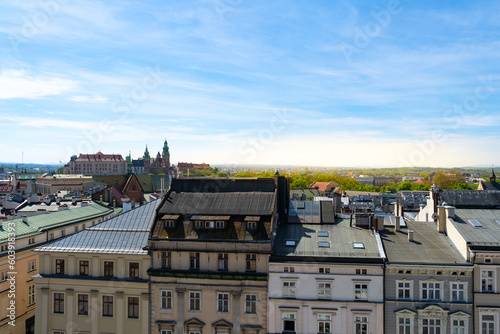 Aerial view of Kraków, Poland. Tenement houses of Cracow old town center district, with view of Wawel Hill Royal Castle complex. Krakow urban architecture.