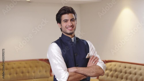 Happy and confident Indian man standing crossed hands photo