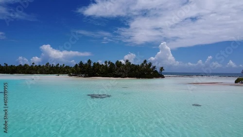 Aerial video of blue water surrounding a tropical island in French Polynesia 
