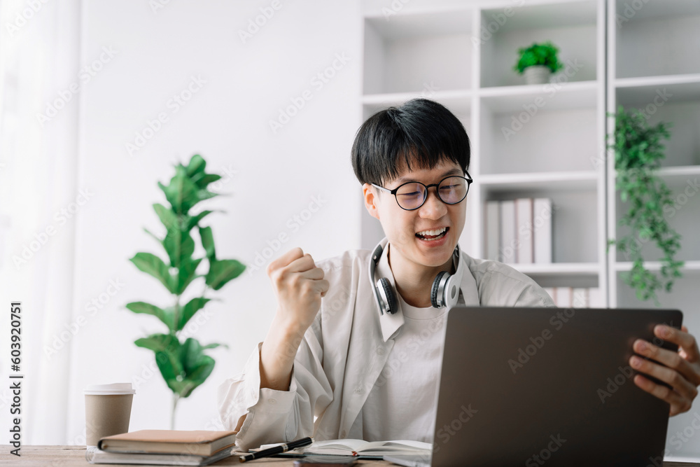 Happy student male says yes, passed an important test, raises hand with fist in excitement, smiles sincerely. Happy student male says yes, passed an important test, raises hand with fist in excitement, smiles sincerely.