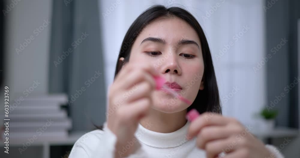 Handheld shot, Beautiful asian woman blogger is showing how to makeup and use cosmetics. In front of the smartphone to record vlog video live streaming at home. Influencer and cosmetics concepts. Handheld shot, Beautiful asian woman blogger is showing how to makeup and use cosmetics. In front of the smartphone to record vlog video live streaming at home. Influencer and cosmetics concepts.