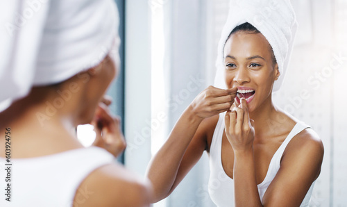 Photos Woman floss teeth in bathroom, mirror and oral hygiene, morning routine with product for dental health