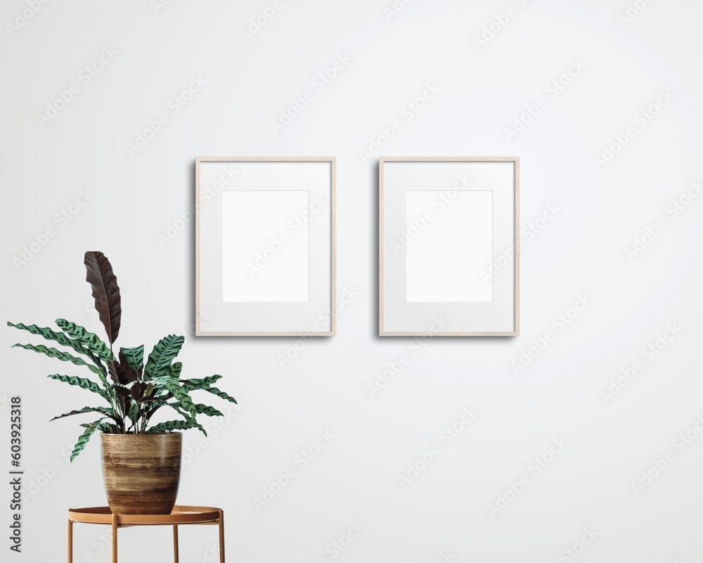 Set of 2 mockup photo frames with house plant against a white wall Set of 2 mockup photo frames with house plant against a white wall