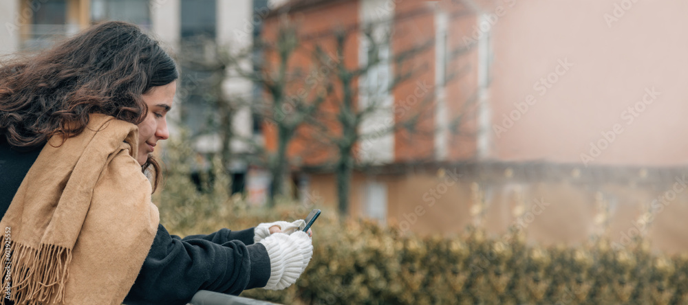 Fototapeta premium young teenager girl with phone in the street