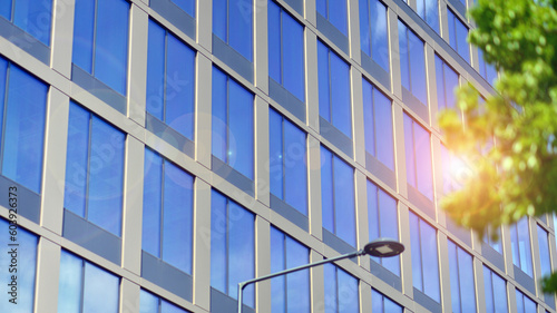 Wallpaper Mural Reflection of modern commercial building on glass with sunlight. Eco architecture. Green tree and glass office building. The harmony of nature and modernity.  Torontodigital.ca