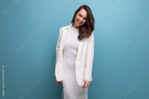 cheerful healthy young lady with dark hair below her shoulders is flirting on a studio background with copy space © Ivan Traimak