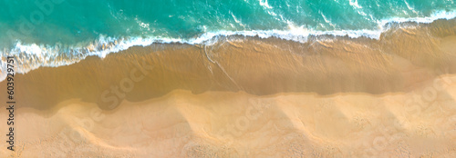 Ocean waves on the beach as a background. Beautiful natural summer vacation holidays background. Aerial top down view of beach and sea with blue water waves	
