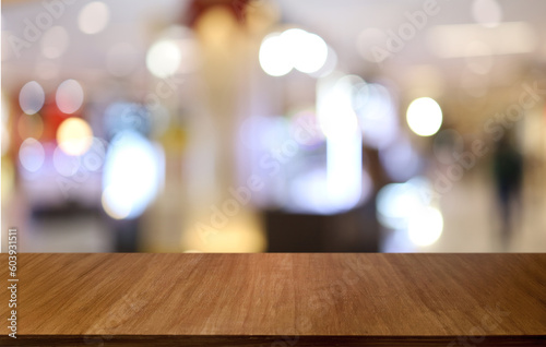 Empty wooden table in front of abstract blurred background of coffee shop . can be used for display or montage your products.Mock up for display of product