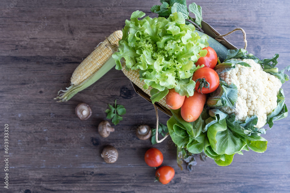 Shopping or delivery healthy food background. a fresh group of vegetables on wood background. burlap bag filled with vegetables and fruits , healthy eating and organic agriculture concept. Shopping or delivery healthy food background. a fresh group of vegetables on wood background. burlap bag filled with vegetables and fruits , healthy eating and organic agriculture concept.