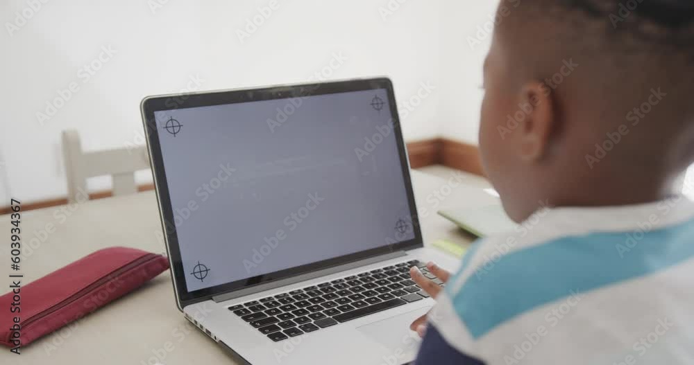 African american boy using laptop with copy space on screen, in slow motion African american boy using laptop with copy space on screen, in slow motion