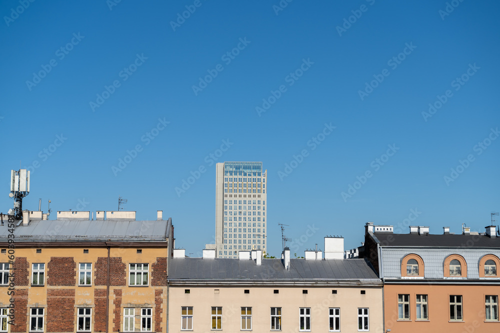 Krakow urban architecture. Aerial view of Cracow tenement houses and Unity Centre Tower, office skyscraper building in Kraków, Poland.