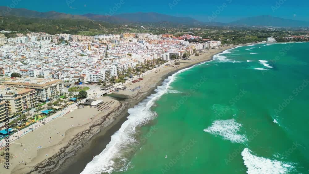 Overhead drone clip of beach and shoreline at the resort town of Estepona, Costa del Sol, Spain, with seabird flying left to right Overhead drone clip of beach and shoreline at the resort town of Estepona, Costa del Sol, Spain, with seabird flying left to right