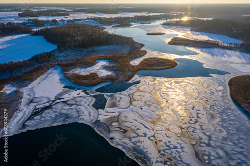 Wallpaper Mural Beautiful winter landscape - drone aerial photo sunset time - frozen Wigry lake, forest and sun reflections in water and ice Torontodigital.ca