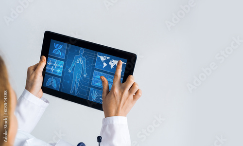 Close of female doctor hands working with tablet pc computer