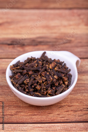 Clove. Dried Clove on wooden background. Spice concept