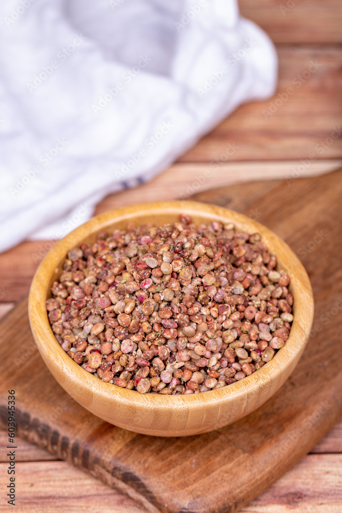Sumac seeds. Dried sumac berries on wooden background. Spice concept Sumac seeds. Dried sumac berries on wooden background. Spice concept