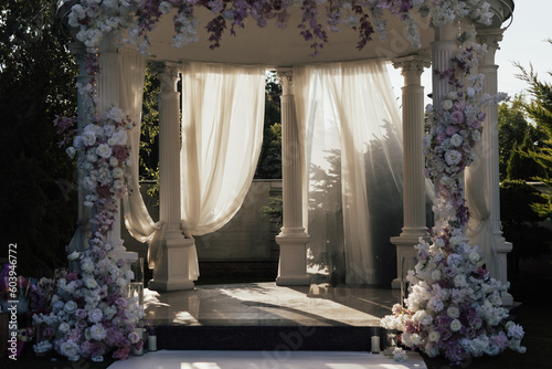 Obraz na płótnie Beautiful wedding set up. Area of the wedding ceremony with round arch, decorated with flowers. Festive decor at nature. w salonie