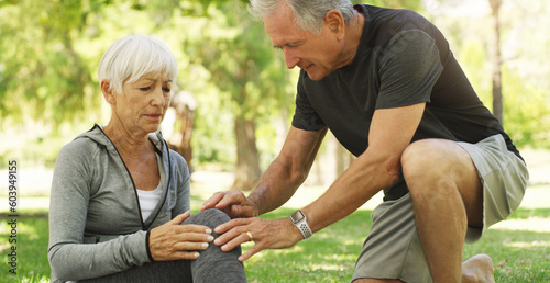 Old couple, woman with knee pain and injury in park, fibromyalgia health problem and joint ache from exercise. Man helping, arthritis and people in retirement with fitness outdoor and muscle tension photo