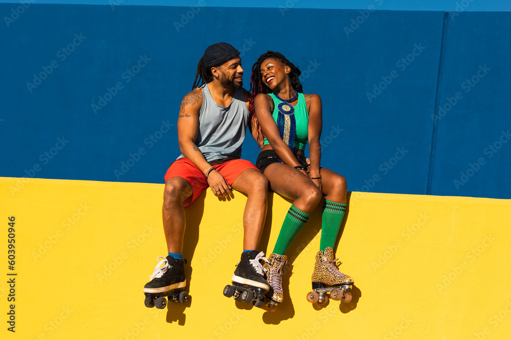 Cheerful couple with roller skating outside. Fun sexy boyfriend and girlfriend enjoy outside. Cheerful couple with roller skating outside. Fun sexy boyfriend and girlfriend enjoy outside.