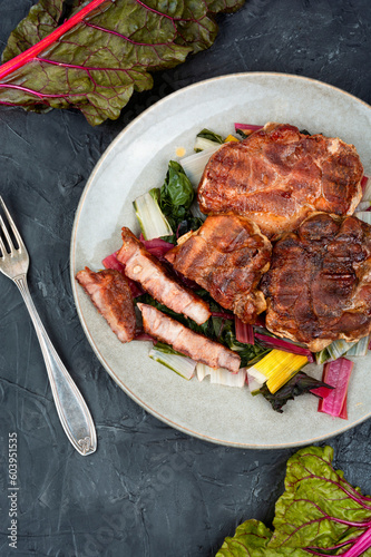 Roast meat steak with a vegetable garnish.