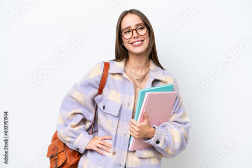 Young beautiful student woman isolated on white background posing with arms at hip and smiling