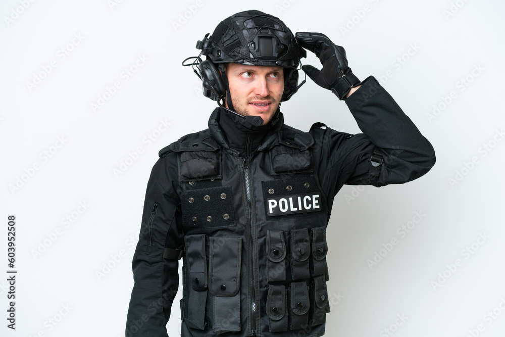 SWAT man over isolated white background having doubts and with confuse face expression SWAT man over isolated white background having doubts and with confuse face expression