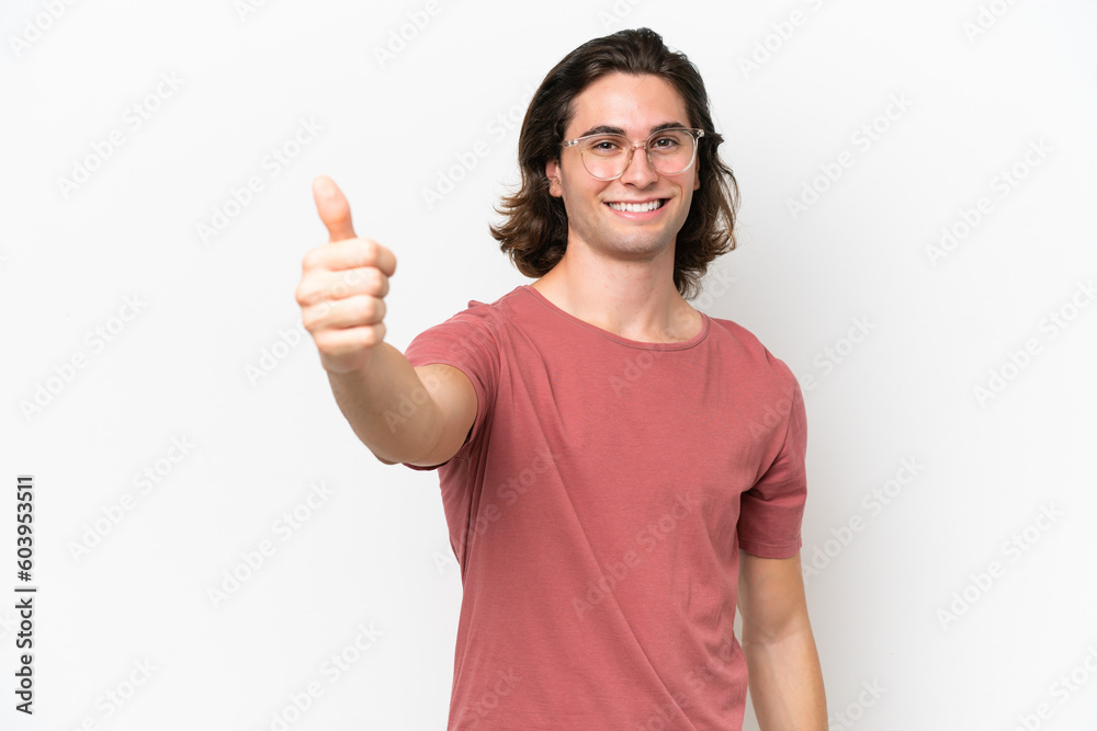 Young handsome man isolated on white background giving a thumbs up gesture Young handsome man isolated on white background giving a thumbs up gesture