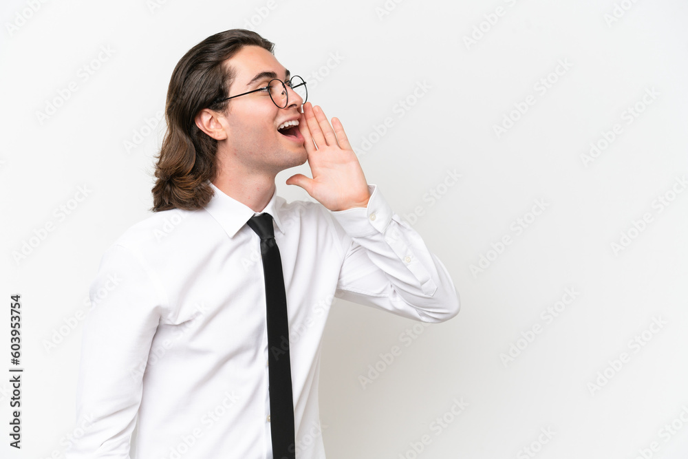 Business handsome man isolated on white background shouting with mouth wide open to the lateral Business handsome man isolated on white background shouting with mouth wide open to the lateral