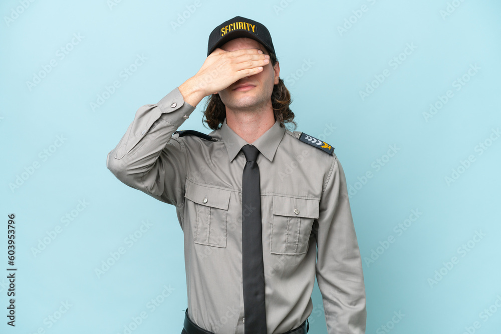 Young safeguard man isolated on blue background covering eyes by hands. Do not want to see something Young safeguard man isolated on blue background covering eyes by hands. Do not want to see something