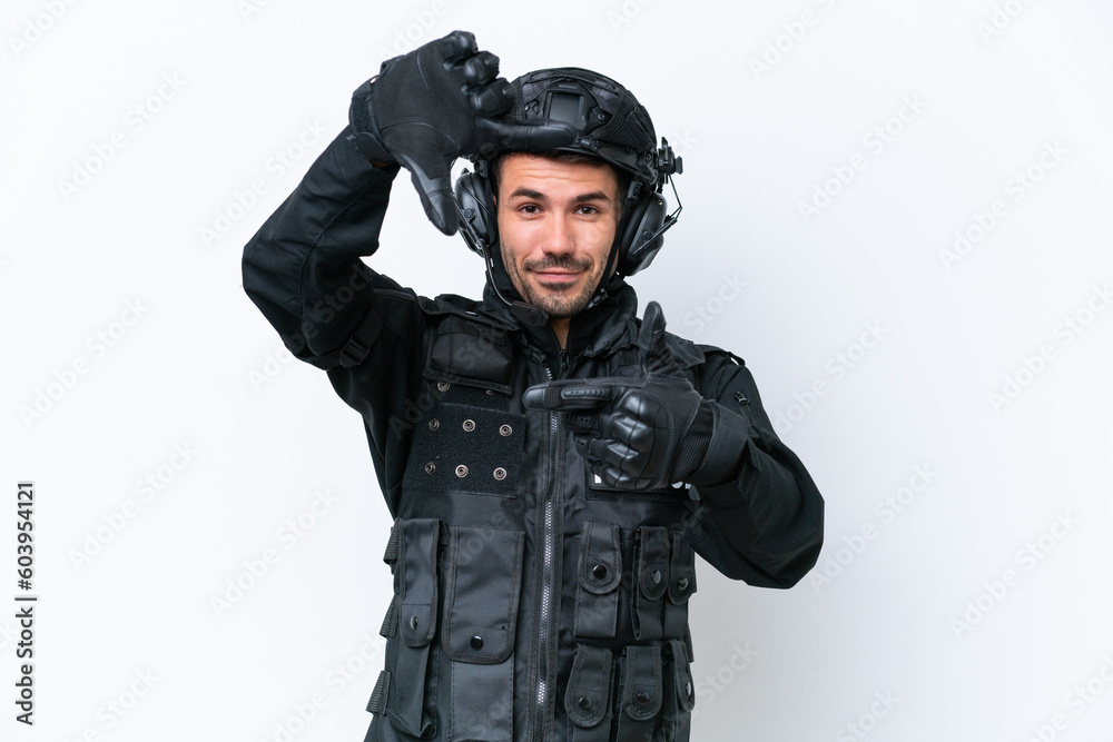 Young caucasian SWAT man isolated on white background focusing face. Framing symbol Young caucasian SWAT man isolated on white background focusing face. Framing symbol