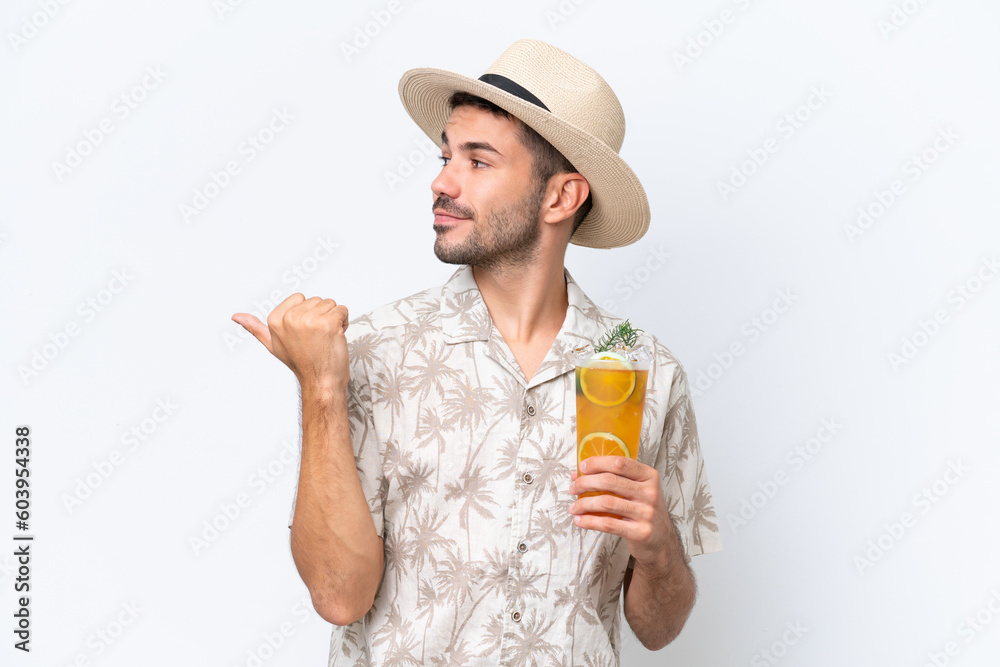 Young caucasian man holding a cocktail isolated on white background pointing to the side to present a product Young caucasian man holding a cocktail isolated on white background pointing to the side to present a product