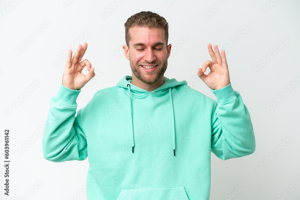 Young handsome caucasian man isolated on white background in zen pose Young handsome caucasian man isolated on white background in zen pose