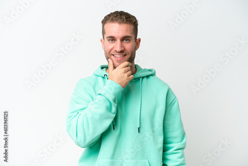 Young handsome caucasian man isolated on white background looking to the side and smiling