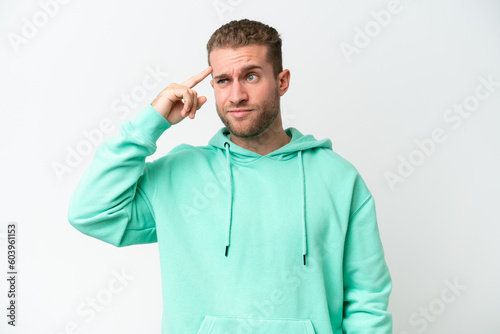 Young handsome caucasian man isolated on white background making the gesture of madness putting finger on the head © luismolinero