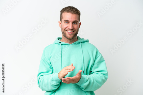 Young handsome caucasian man isolated on white background applauding © luismolinero