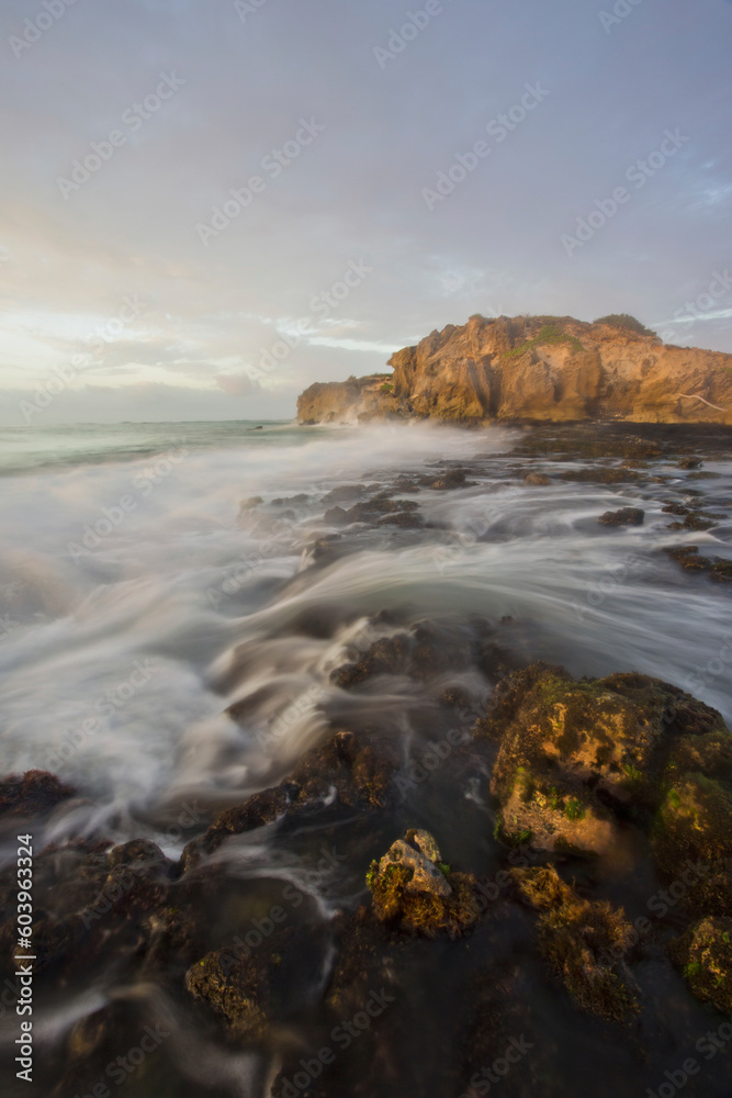 Long exposure of waves by at coast during sunset Long exposure of waves by at coast during sunset