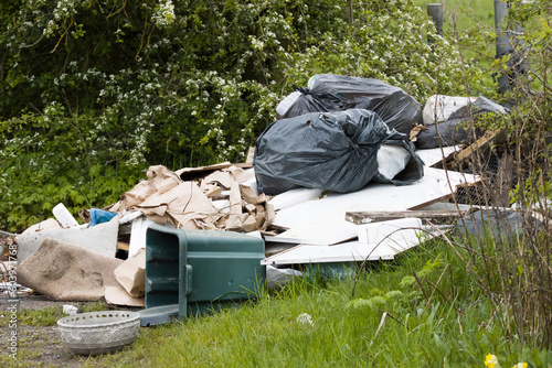 Naughty Illegal Rubbish being dumped on countryside roads in the United Kingdom, which has adverse effects.